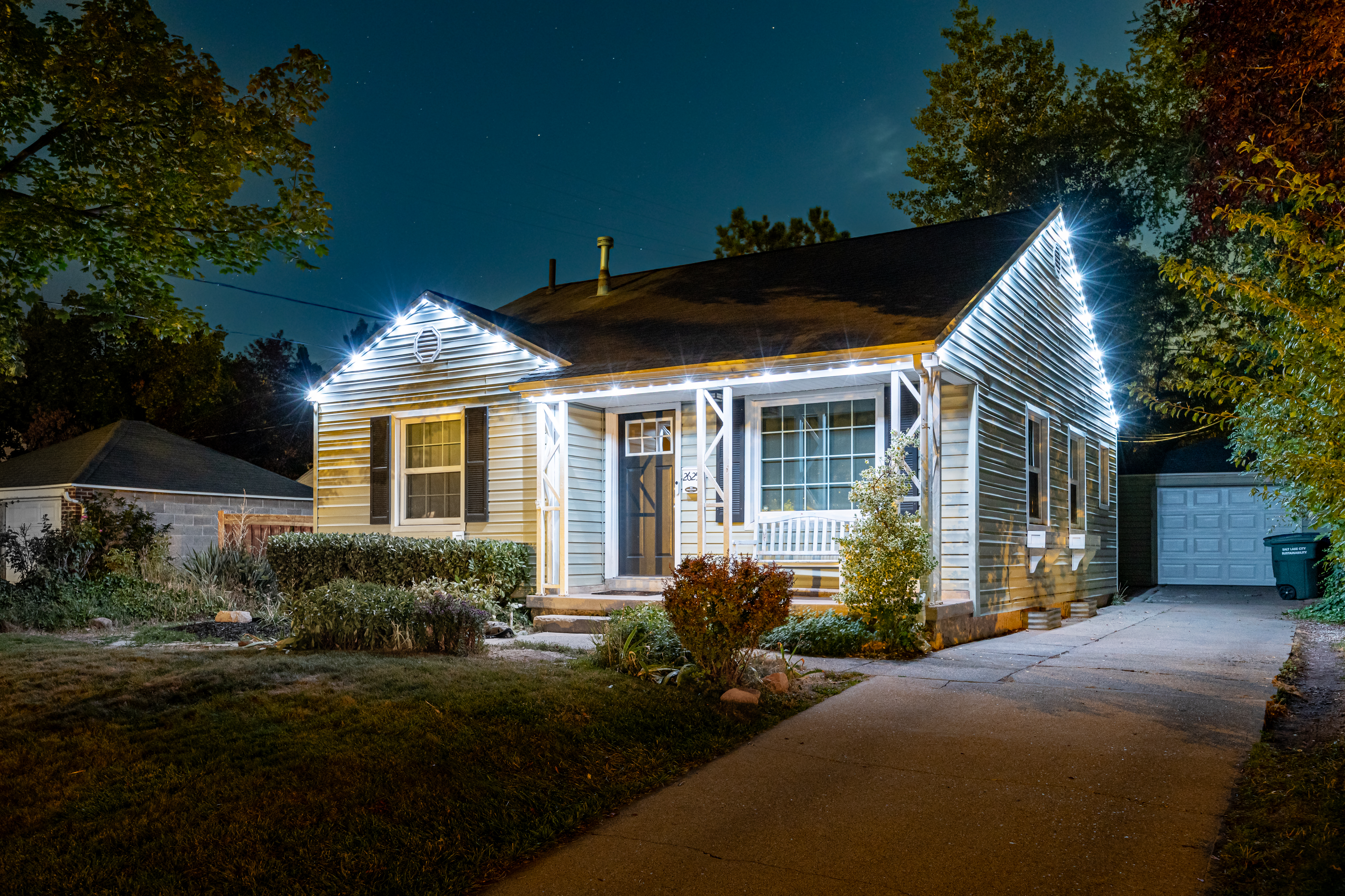 Ladder and temporary holiday lights on a home