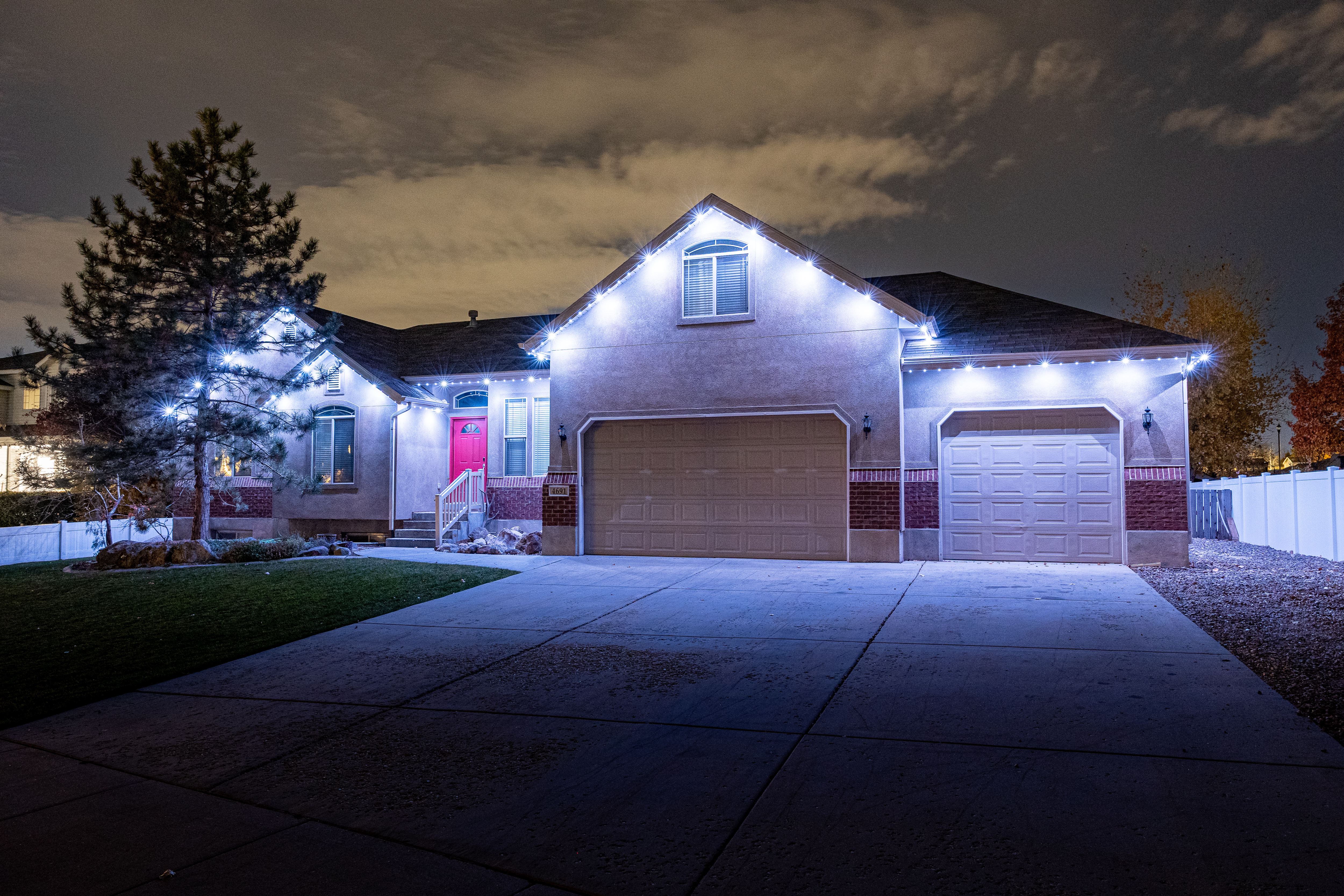 Home exterior with permanent roofline lighting